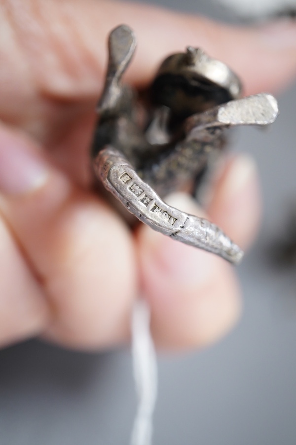 An Elizabeth II silver four piece miniature cat band by S.J. Rose & Son, Birmingham, 1976, tallest 58mm, together with a modern 925 miniature model of a standing grizzly bear and a modern silver model of a kitten(filled)